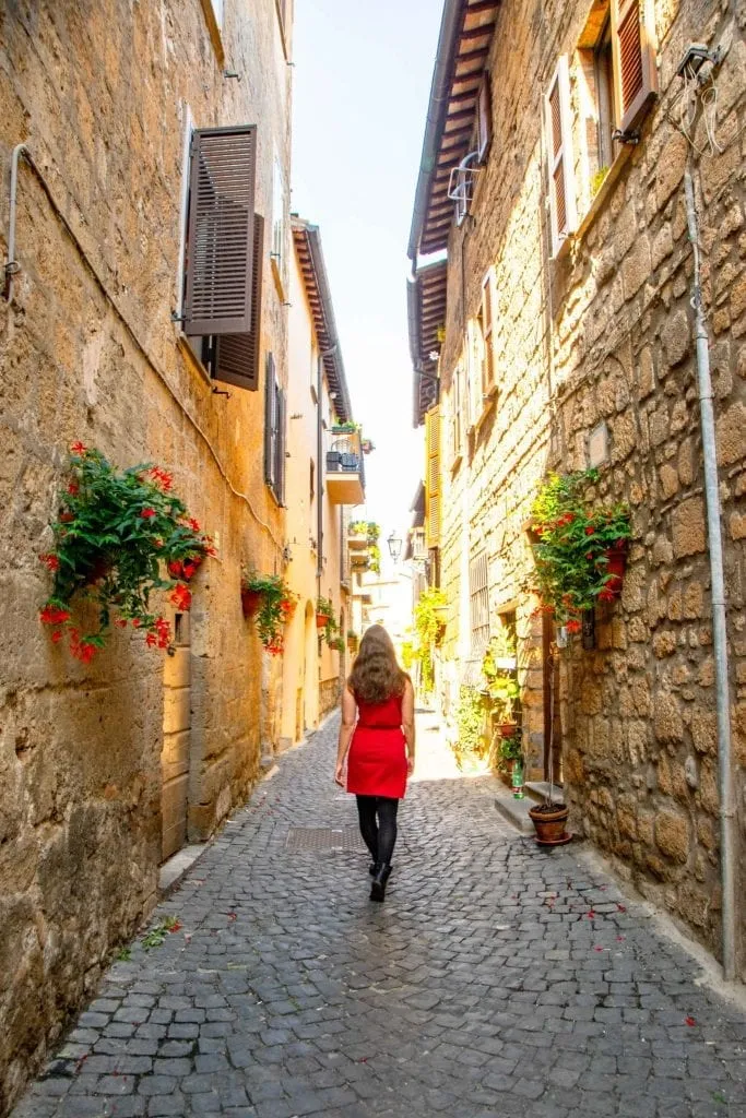 kate storm wandering a small side street in italy budget guide