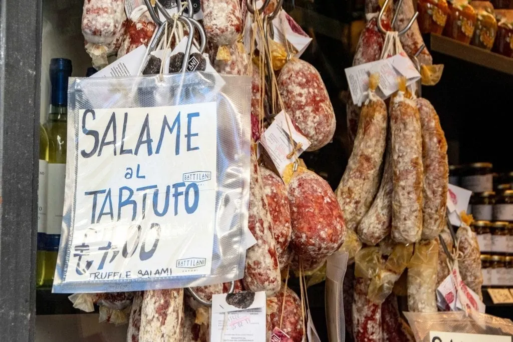 selection of salamis hanging in a shop in orvieto, one of the best souvenirs from Italy