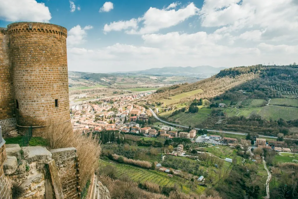 stone tower to the left with umbrian countryside visible to the right