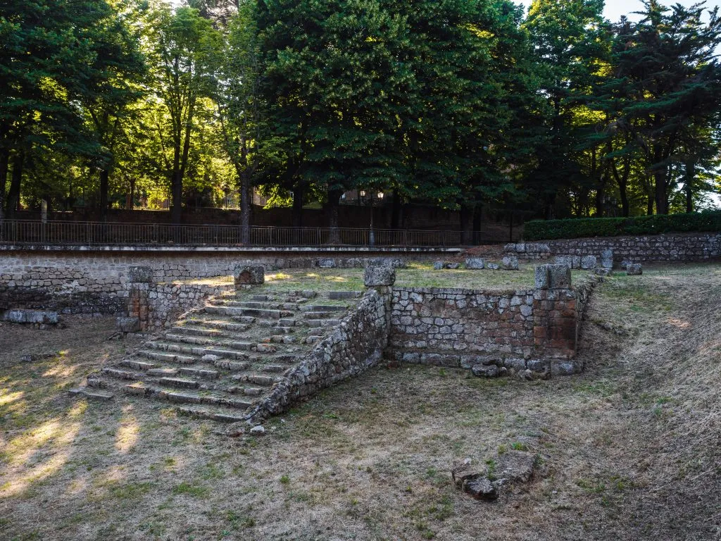 stone ruins of Temple of Belvedere shaded by trees