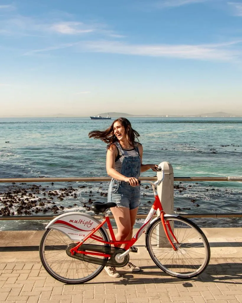 kate storm with a red bike at sea point cape town