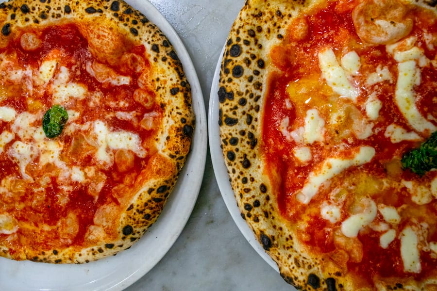 two Pizzeria da Michele pizzas as seen from above on a naples pizza tour, one of the best things to do in italy