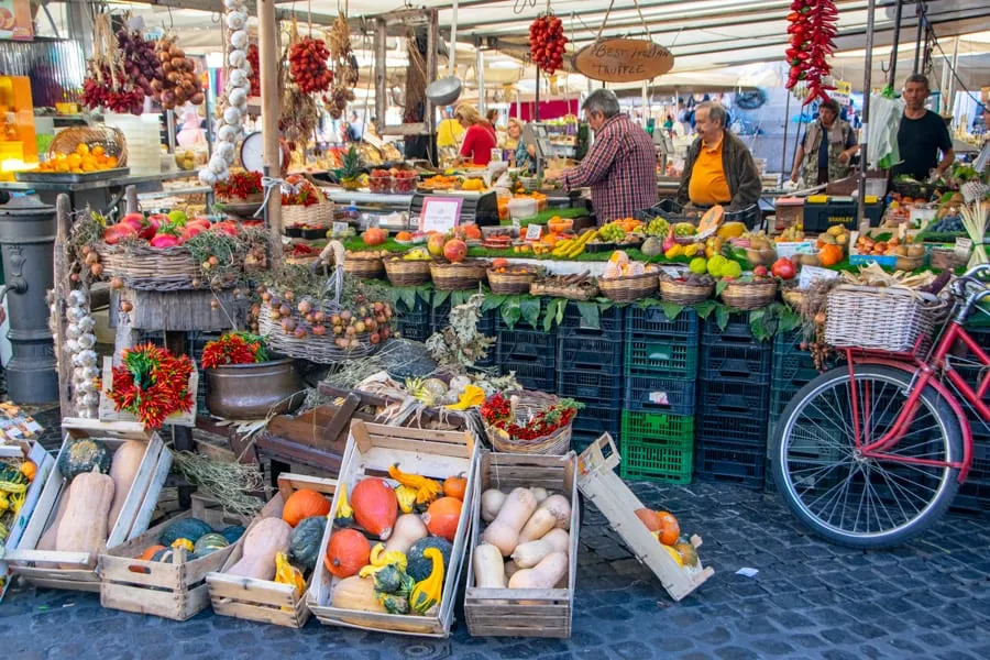 Campo de'Fiori market stalls decorated for fall with a bike to the right