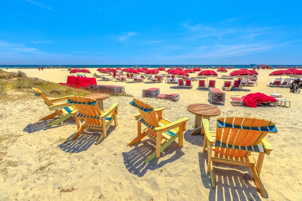 red and yellow chairs spread out on the coronado island beach