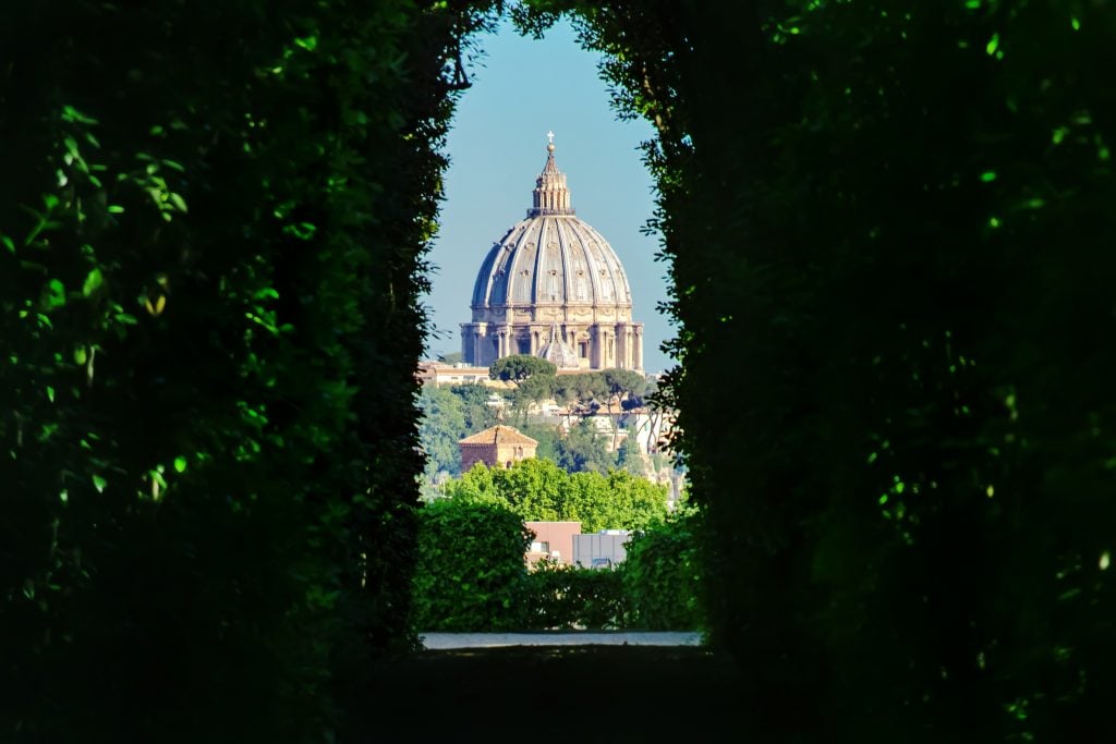 view of st peters basilica through keyhole on aventine hill