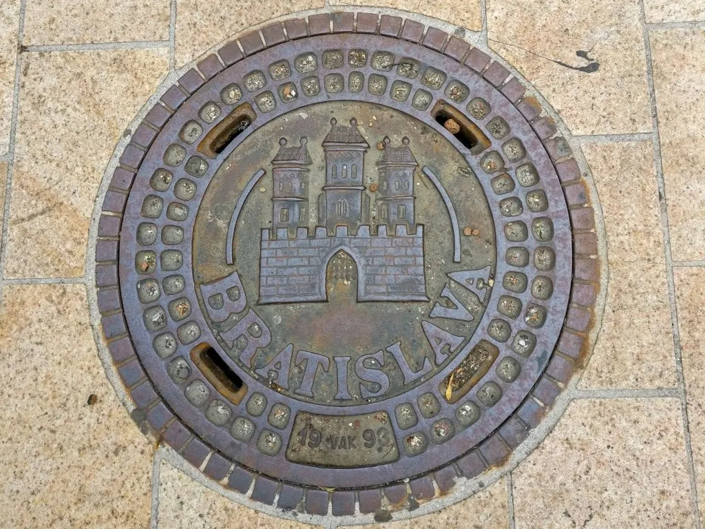 Prague Vienna Budapest Bratislava Central Europe Itinerary: Bratislava Manhole Cover with Castle