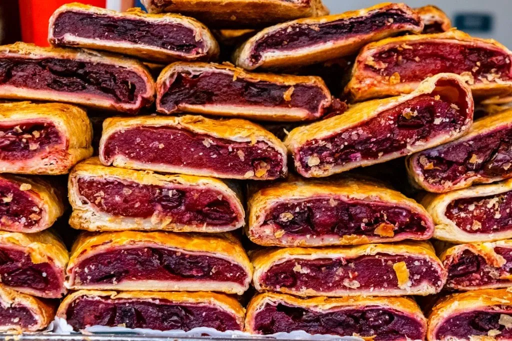 cherry strudel in a pile at a budapest market, one of the best budapest foods to try