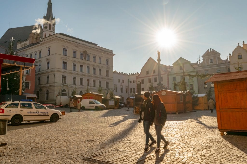 couple walking through Svornosti Square cesky krumlov december