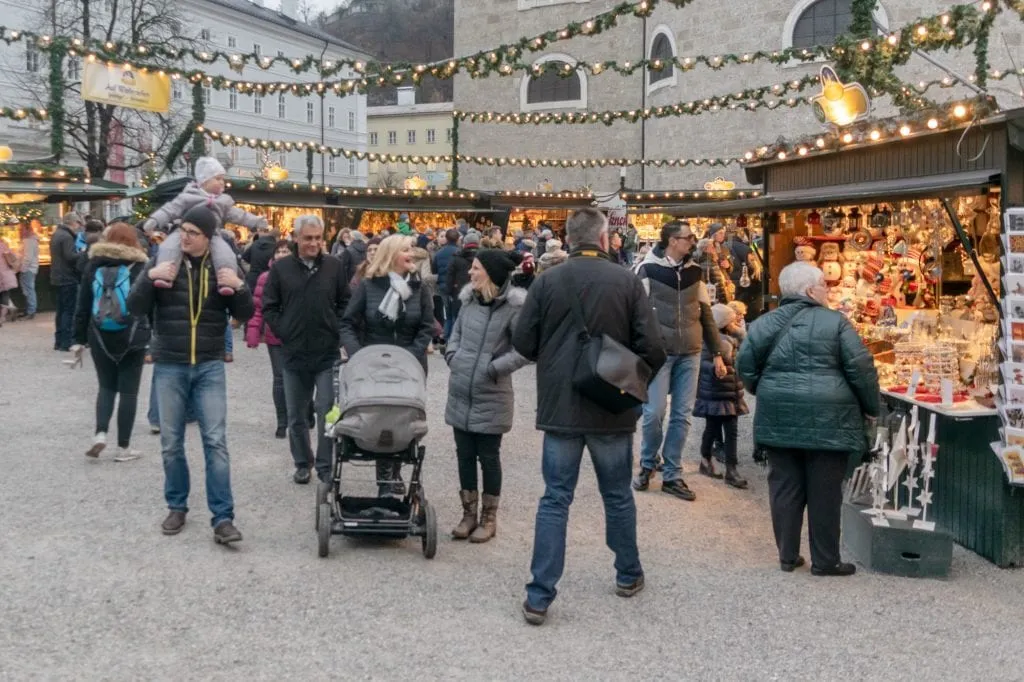 crowd of people shopping salzburg at christmas