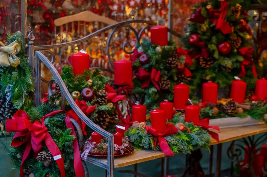 advent wreaths with red candles for sale at market stall