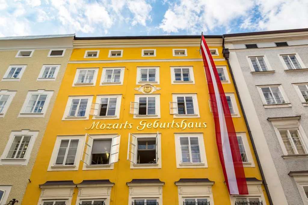 yellow front facade of mozart birthplace, one of the top attractions in salzburg austria