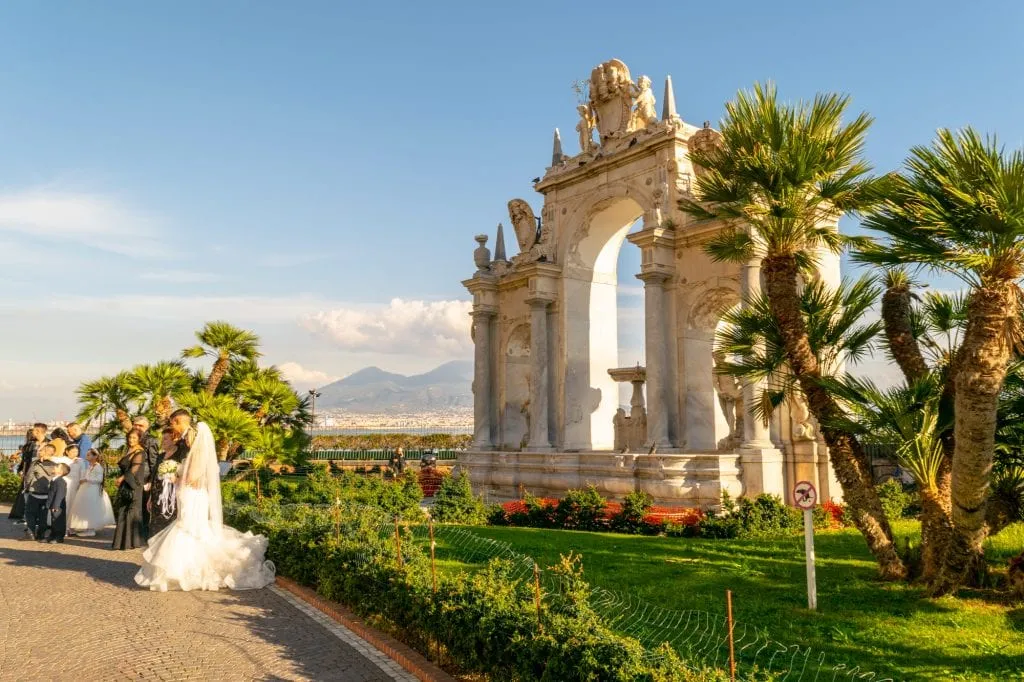 photo of a wedding taking place along the coast in naples, a beautiful italy proposal ideas