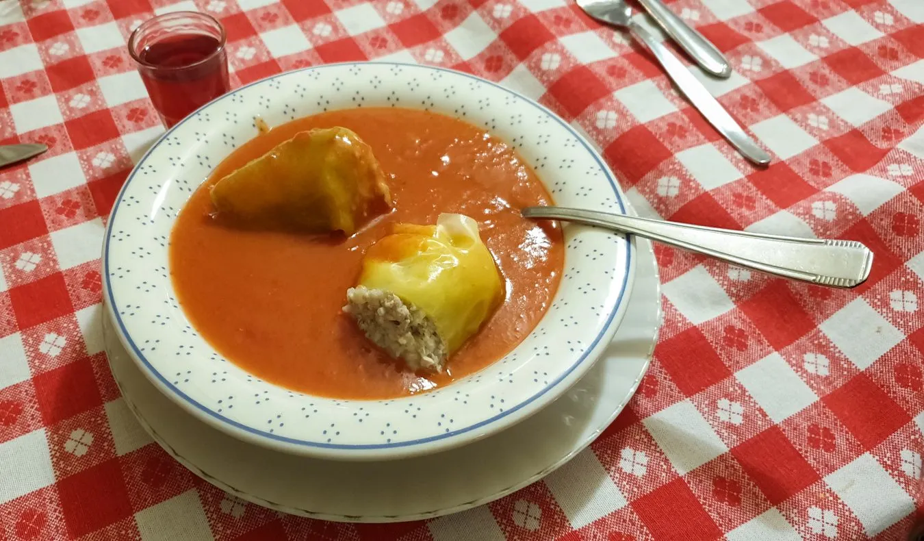 hungarian stuffed peppers with paprika served over a red and white checkered tablecloth