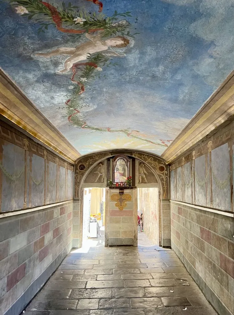 inside of Passetto del Biscione near campo de fiori rome with frescoes on the ceiling