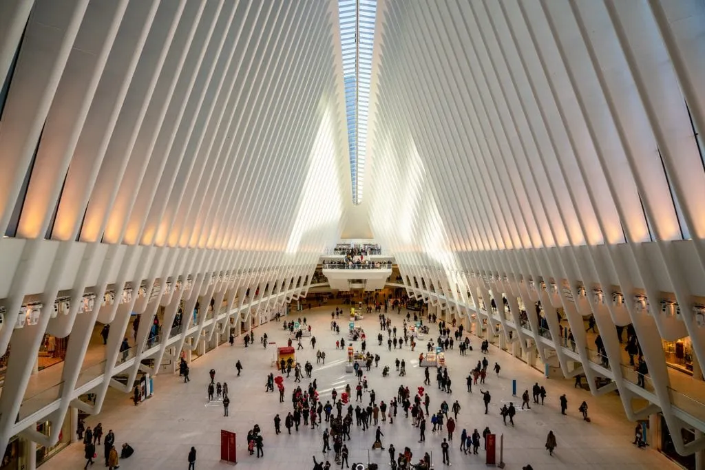 Interior of the Oculus Building in NYC with shoppers visible down below. It's worth stopping here for a oment during your one day in New York City!