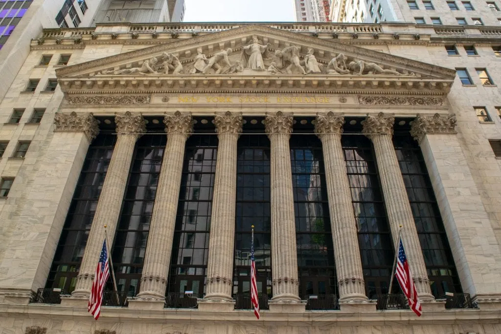 front facade of the new york stock exchange in nyc financial district with columns out front