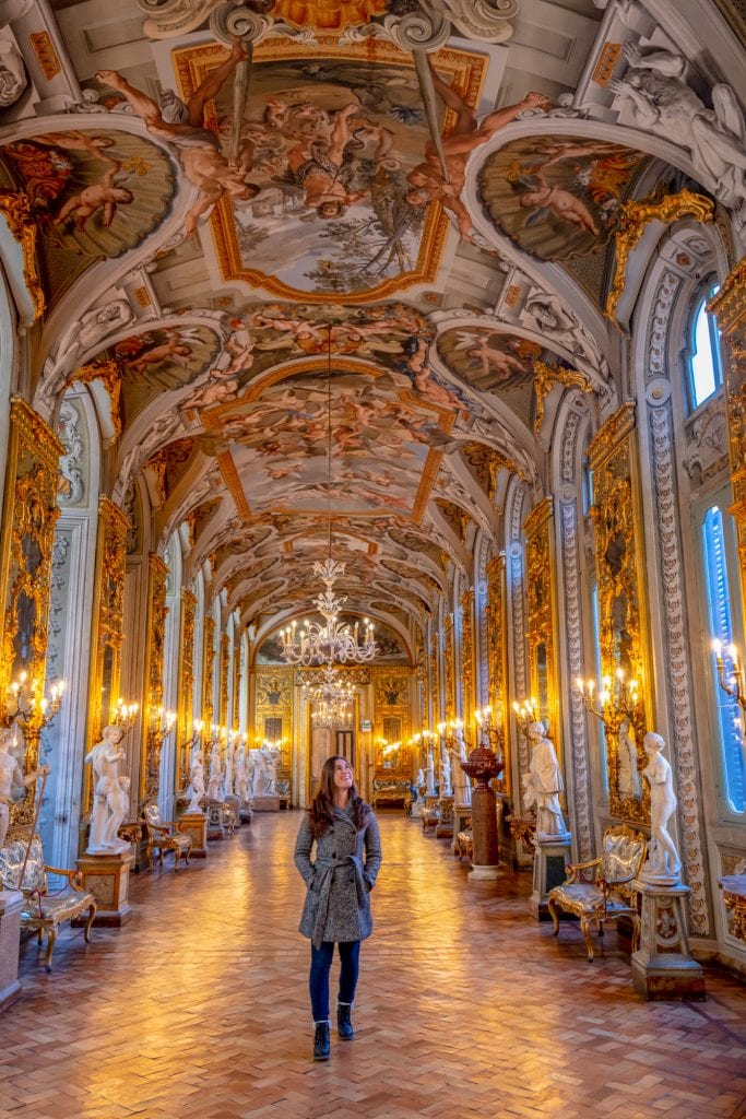 kate storm walking through the Palazzo Doria Pamphilj, one of the best hidden gems in rome italy