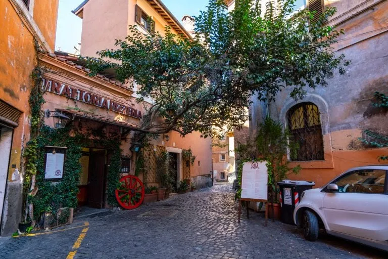 car and restaurant in a quiet hidden corner of rome, as seen on a trastevere food tour