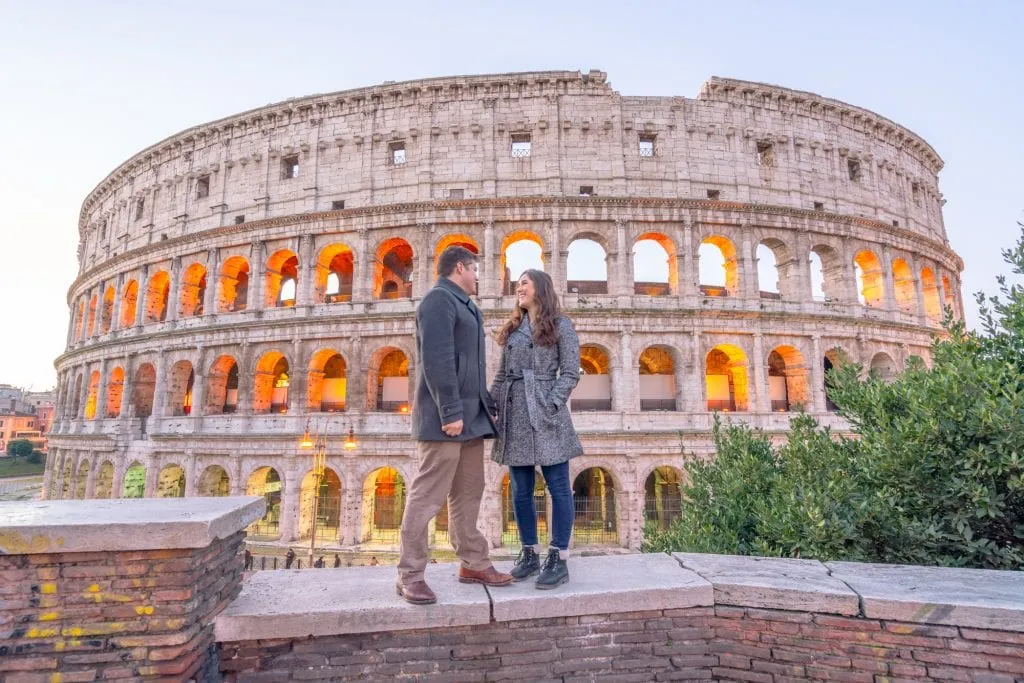 What to Wear in Rome: Couple wearing coats in front of the Colosseum