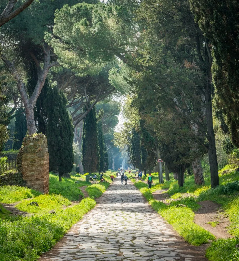 people enjoying the appian way on sunday in rome in summer