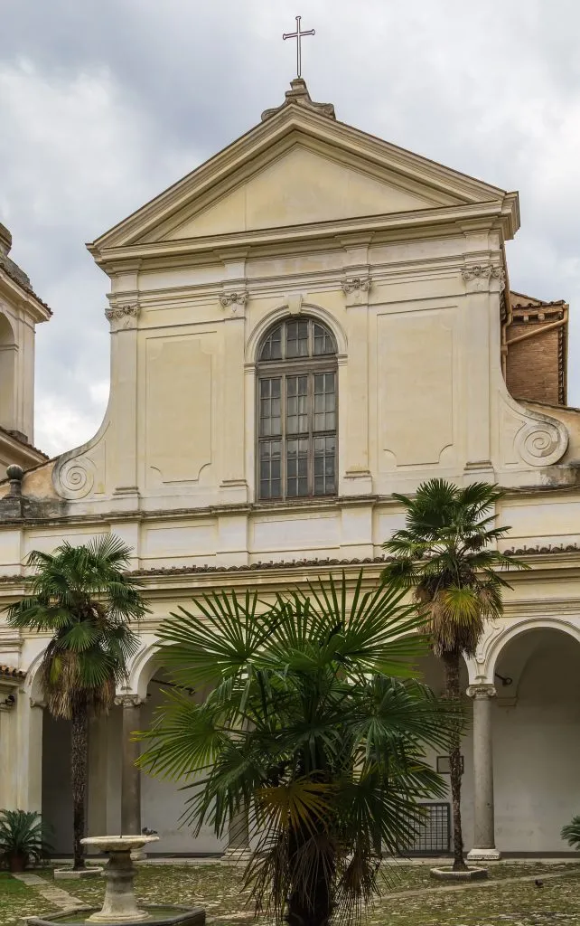 front facade of the basilica of san clemente in rome on a cloudy day