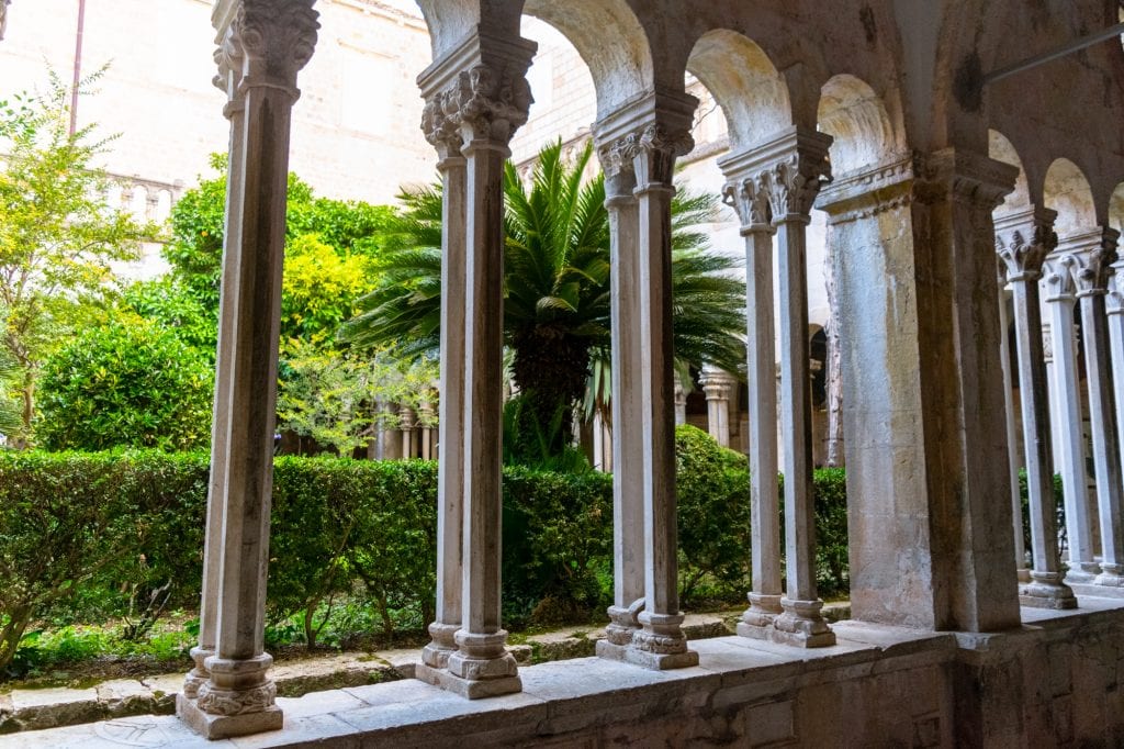 cloisters of monastery surrounding green square in dubrovnik croatia