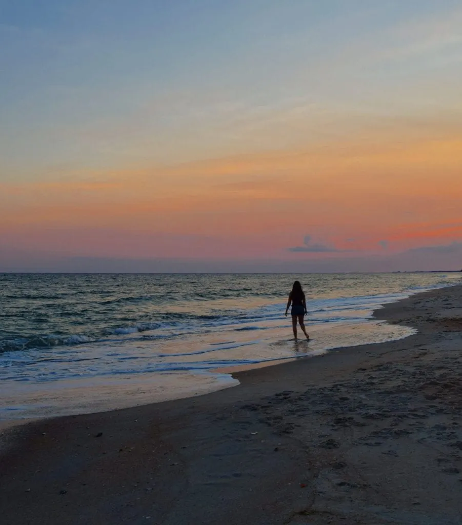 kate storm standing on atlantic beach at sunset. visiting atlantic beach belongs on any list of what to do in beaufort north carolina