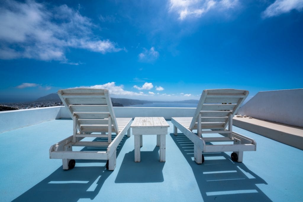 Sun chairs on blue rooftop in Santorini, 3 days in Santorini itinerary