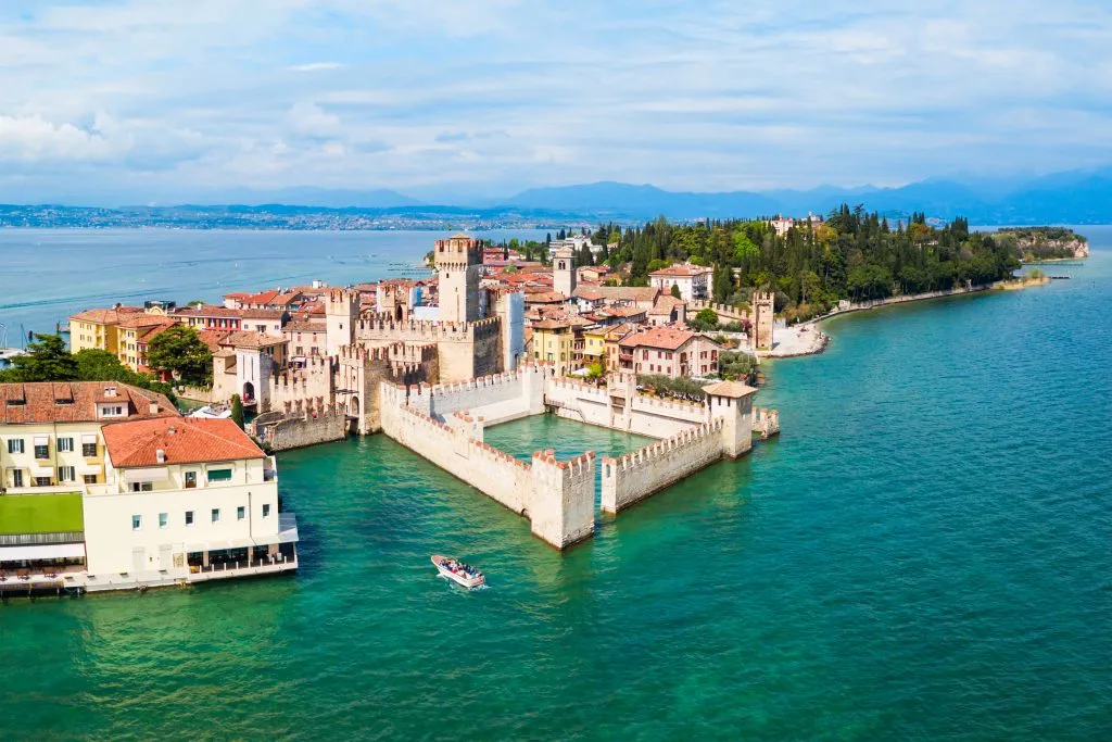 aerial view of sirmione italy with castle in the foreground surrounded by the sea