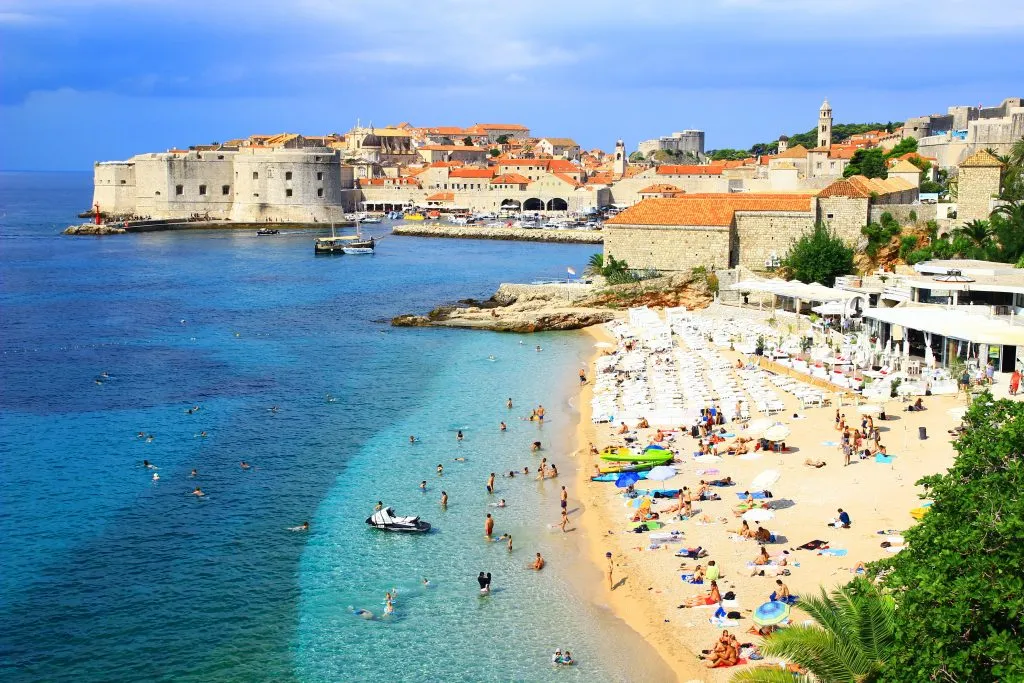 banje beach dubrovnik, one of the best beaches dubrovnik croatia with skyline in background