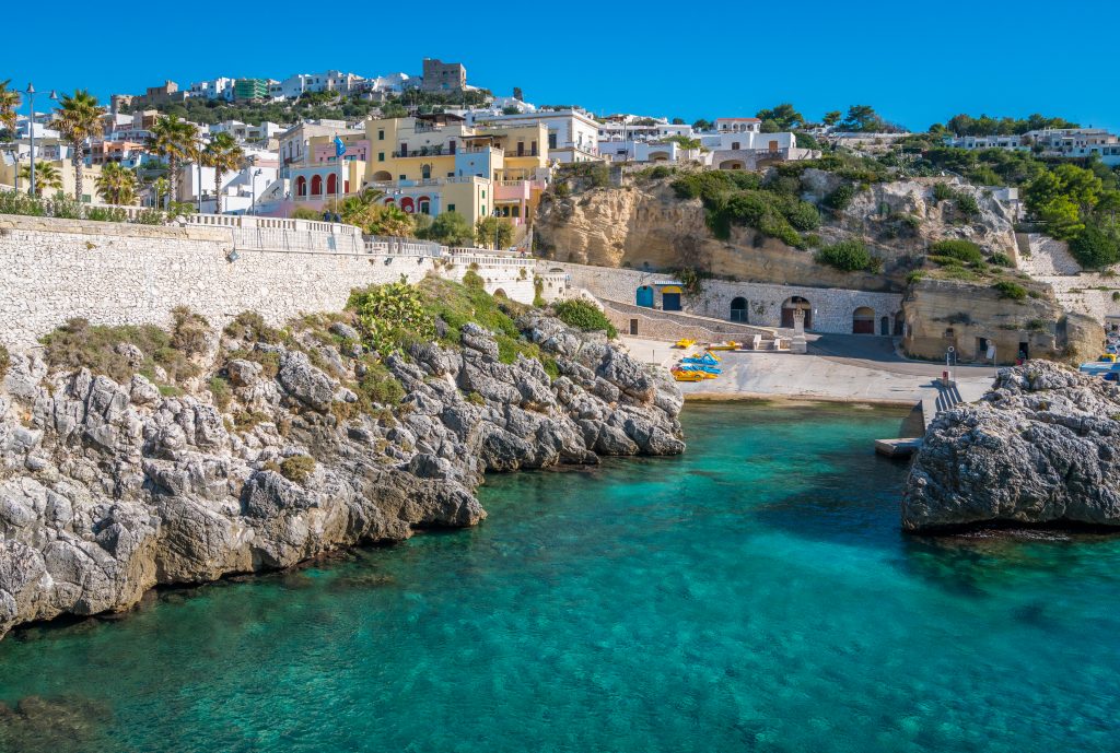 white town of castro puglia as seen from the water