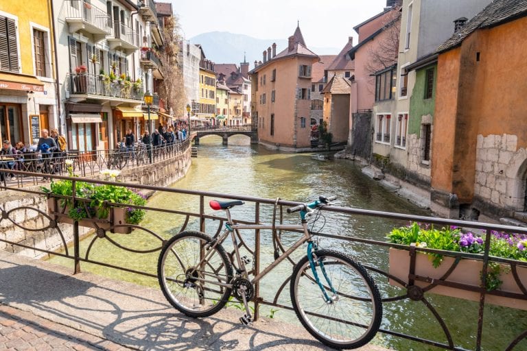 Bike leaning against bridge over a canal in Annecy, France