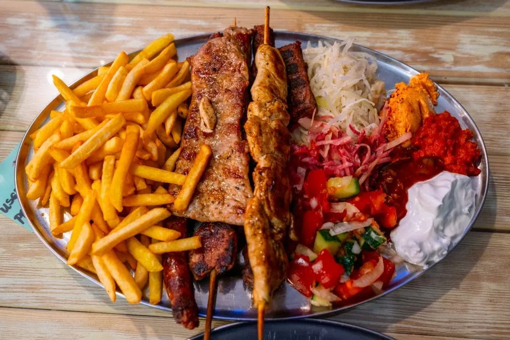 Plate of Grilled Meat at Tanjga Family Restaurant in Kotor, shot from above. Fun Things to Do in Kotor Montenegro