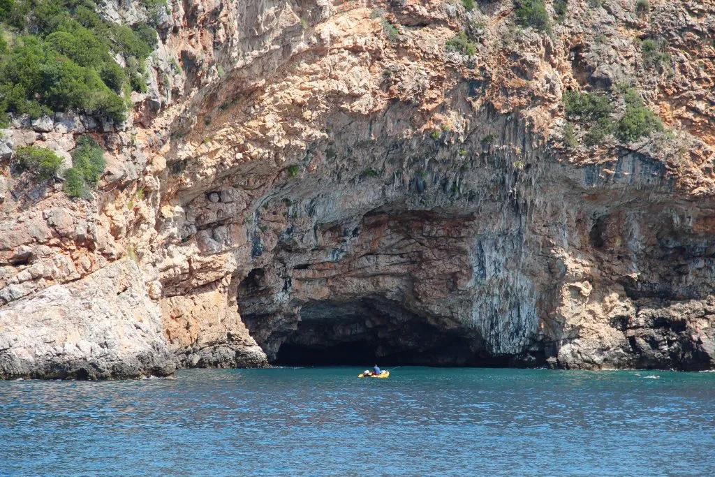 view of blue cave kotor montenegro from across the water, one of the best places to visit in kotor montenegro