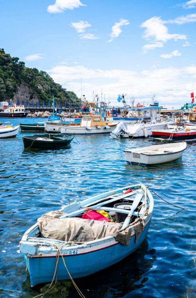 Small fishing boat tied up near Sorrento, Italy. Other boats are in the background.