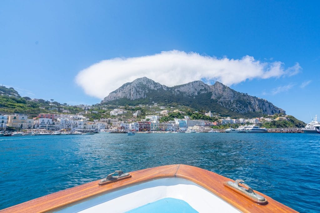 Mariana Grande, Capri, as seen from a boat, with bow of boat in the foreground.