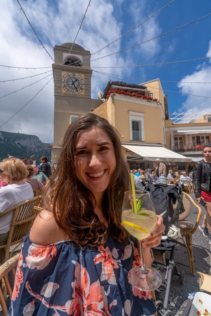 Woman drinking lemon spritz in Piazzetta on a day trip to Capri