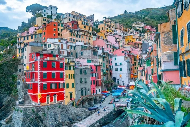 Riomaggiore at sunset from viewpoint above the town, Cinque Terre: visiting here if at all possible is definitely among our best travel tips for Italy!