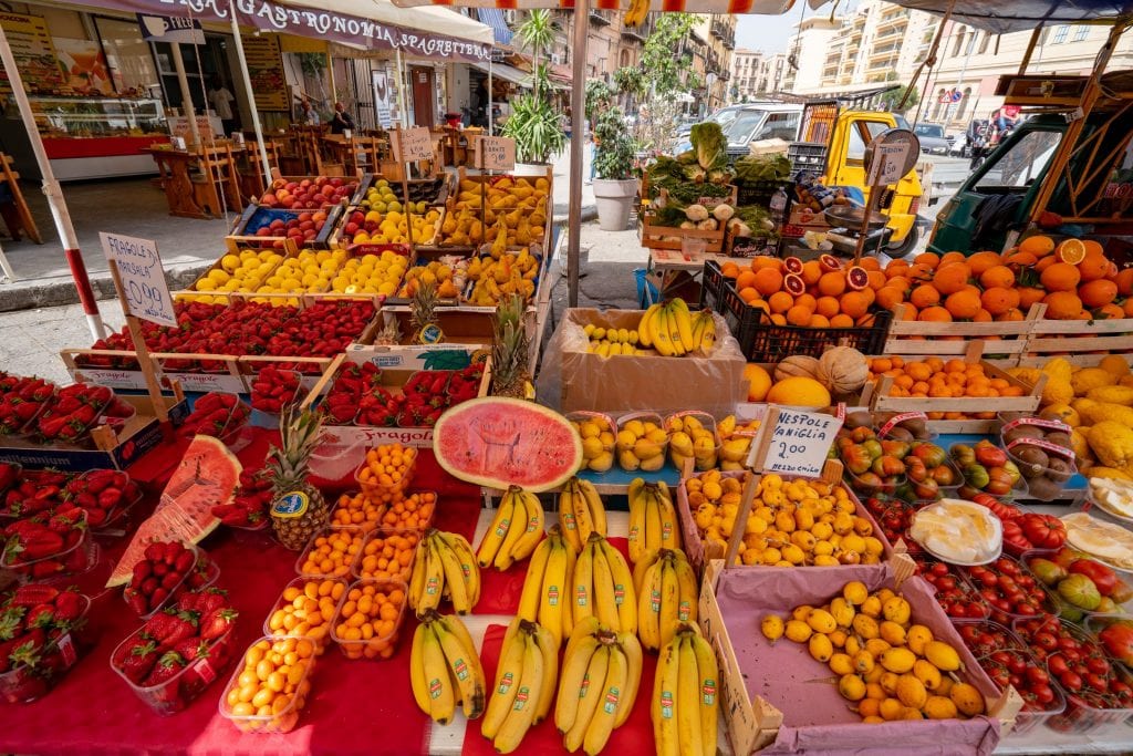 shopping in local markets like this one in palermo belongs on any tips for how to save money to travel the world