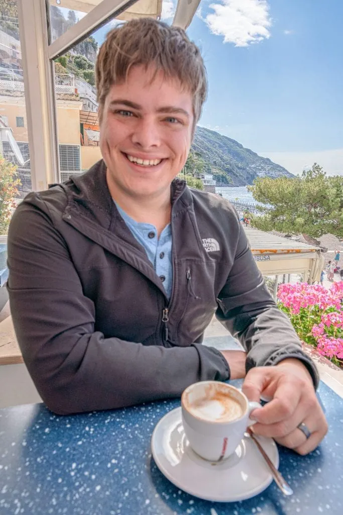 Man drinking a cup of coffee in Positano along the Amalfi Coast, Italy