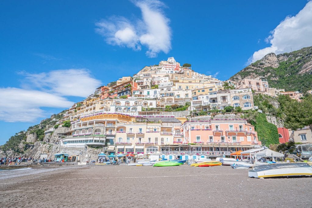 Photo of Positano, taken from the perspective of looking up from the beach. Positano is an essential stop on a Amalfi Coast itinerary!