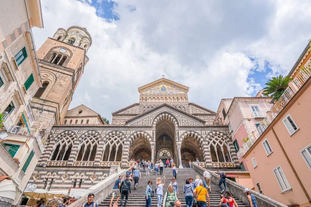 Facade of Duomo in Amalfi Town with crowd on the steps in the foreground.