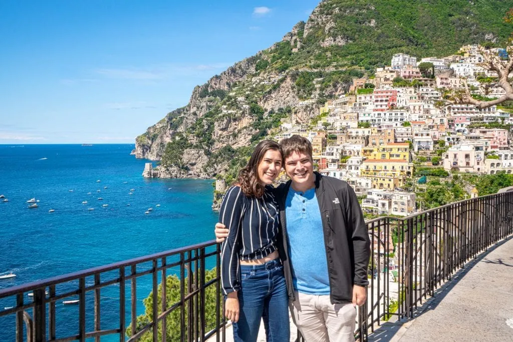 Couple on a balcony overlooking Positano