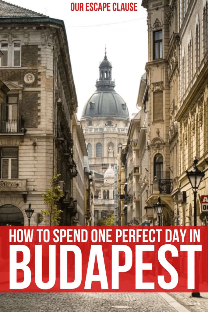 Photo of street in Budapest that dead-ends into Budapest Opera House. Text on the bottom of the image says "How to Spend One Perfect Day in Budapest", and the text is white on a red background.