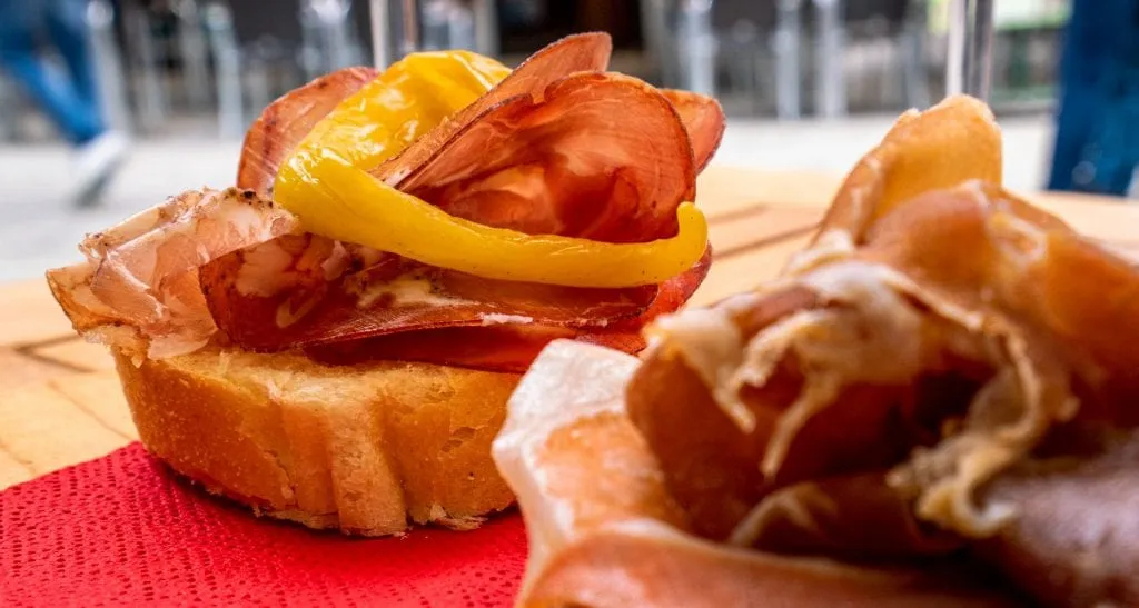 Close up of cicchetti topped with prosciutto