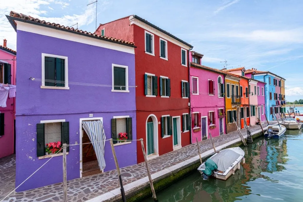 Street in Burano with purple house in foreground.