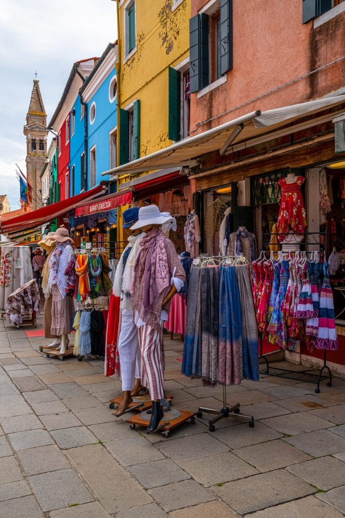 Street of Burano with clothes being displayed in front of a shop