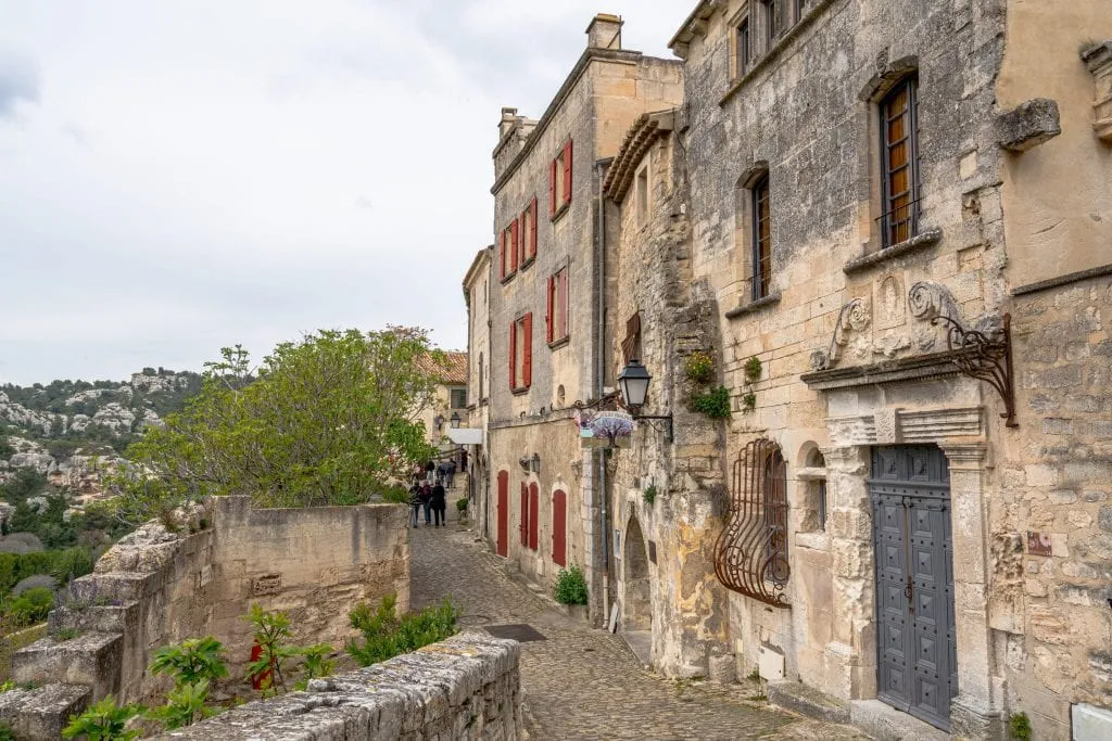 Cobblestone street and stone buildings in Les Baux-de-Provence--don't forget to add this village to your South of France itinerary!