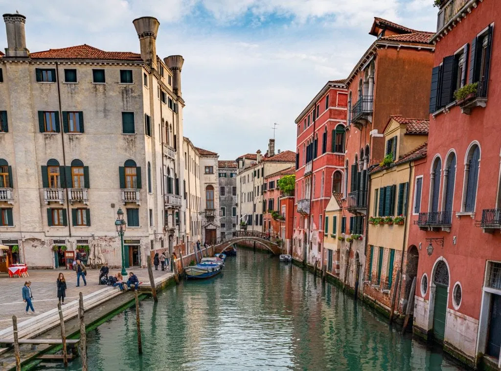 Photo of Venice canal with footbridge in the distance