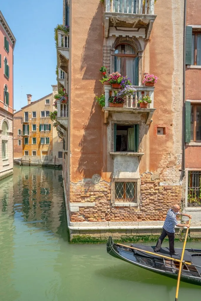 Photo of Venice Canal with a gondolier paddling in the corner